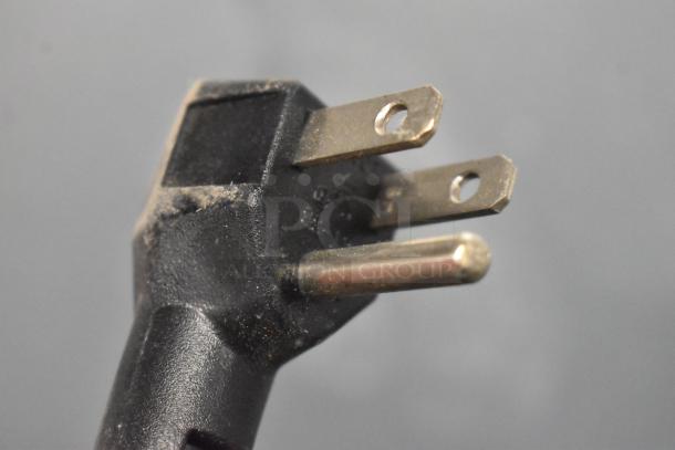 Close-up of a power plug for the 2021 Atosa MBF8002GR reach-in freezer, showing three-prong metal connectors.