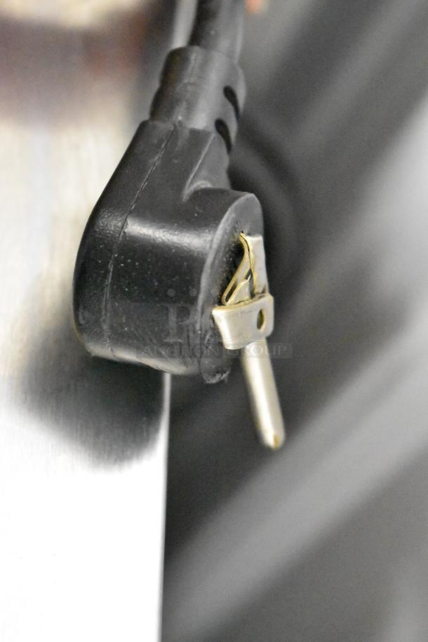 Close-up of a black power plug on the Delfield 406P-STAR2 stainless steel cooler.