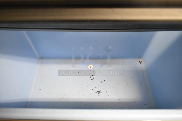 2019 Ice-O-Matic B110PS stainless steel ice bin interior with minor debris, showcasing the bin's spacious capacity and condition.