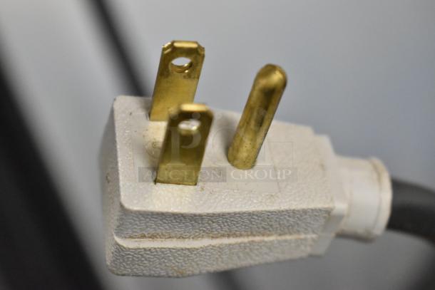 Three-prong power plug of the 2018 True TG2R-2S-HC commercial reach-in cooler, 115 volts, showing the prongs in detail.