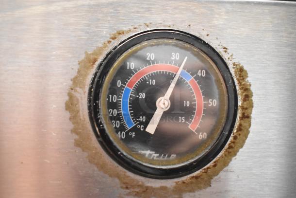Close-up of True T-35 cooler temperature gauge, showing Celsius and Fahrenheit readings, minor rust around the edge.