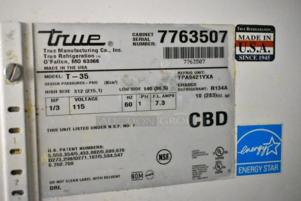 True T-35 stainless steel commercial 2-door cooler, poly-coated racks, 115V, 1 phase. Serial 7763507, Energy Star rated.