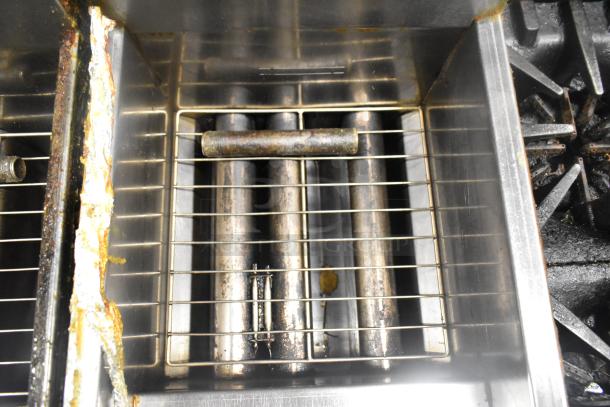 Dean SR42GN stainless steel commercial deep fat fryer. 105,000 BTU. Visible wear on interior surfaces. Natural gas powered.