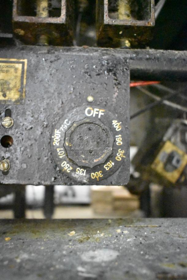 Dean SR42GN stainless steel commercial gas fryer, 105,000 BTU. Shows temperature dial and worn surface.