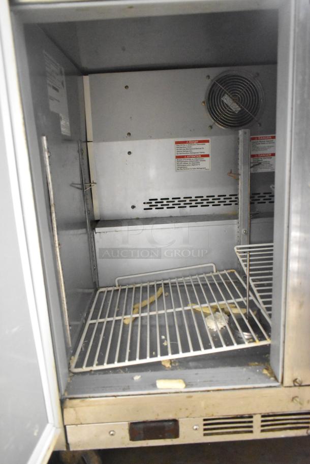 Beverage Air WTF36AHC stainless steel 2-door work top freezer. Features commercial casters, shelves, and visible interior markings.