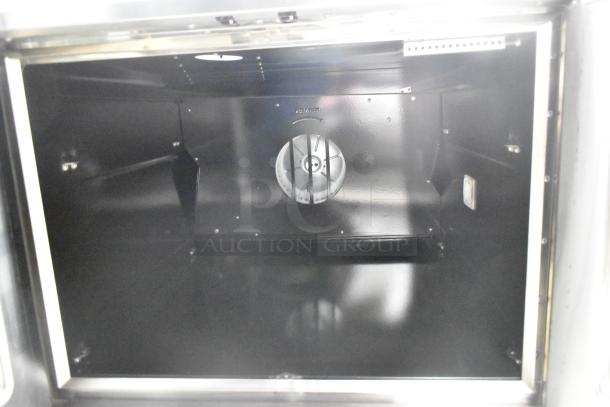 Cooking Performance Group 351FGC100DDN stainless steel convection oven interior; spacious, with a central fan.