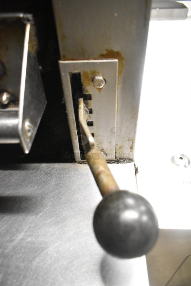 Garland stainless steel commercial vertical broiler control handle. Features visible rust and wear, indicating used condition.