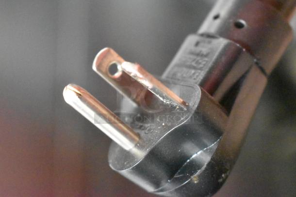 Close-up of a 115V plug for the 2024 Metro C5HME053968 Heated Holding Proofer, showing intact prongs and casing.