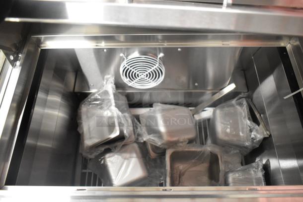 2021 Atosa MSF8301GR stainless steel prep table interior, showing multiple wrapped pans and cooling fan. Mint condition.