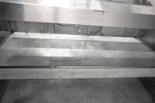 Broaster metal commercial 2-tier warming display case, visible "Caution Hot" label, 115 volts, 1 phase, used condition.