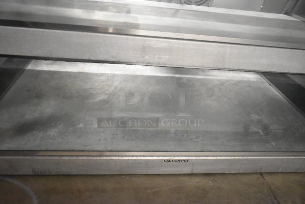 Broaster metal commercial 2-tier warming display case, 115 volts, 1 phase. Features "Caution: Hot" label.