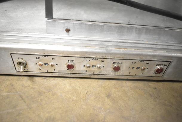 Broaster metal commercial 2-tier warming display case, controls showing settings for lights and heat levels. 115 volts, 1 phase.