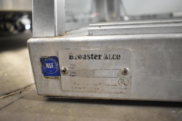 Broaster metal commercial 2-tier warming display case, NSF certified. Features 115 volts, 1 phase. Visible wear and label details.