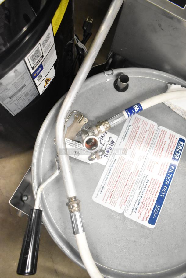 Brand new Miroil 75 lb. electric fryer oil filter machine with 1-way pump, 120V, detailed labels, slightly dented.
