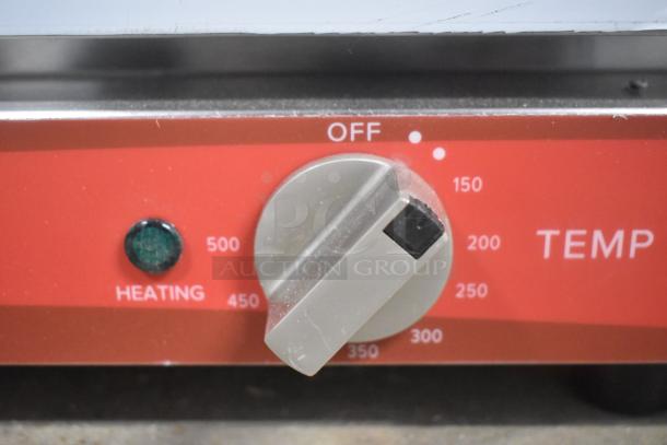 Close-up of Avantco 177CO14 convection oven control panel showing temperature dial and heating indicator.