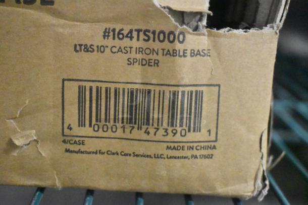 Cardboard box showing label for Lancaster Table & Seating 10" cast iron table base spider, model #164TS1000. Box has minor dents.