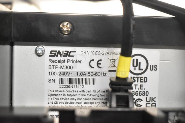 SNBC BTP-M300 Receipt Printer label indicating model, voltage 100-240V, 1.0A, 50-60Hz, UL listed, CE certified.