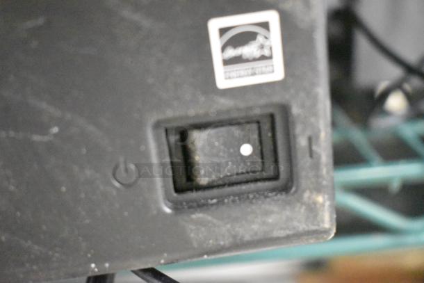 Close-up of a power switch and energy star label on electronic device in used condition.