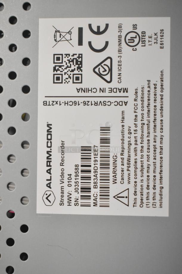 Label on electronic device with manufacturer "Alarm.com," model "Stream Video Recorder," hardware version "0104," serial number "J03519588," and MAC "B83A9D191EE7."