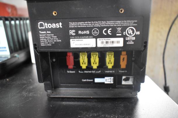 Toast TP200 Receipt Printer with labels showing model and serial number. Connections include "To Stand," "Internet Out/In," and "Power In."
