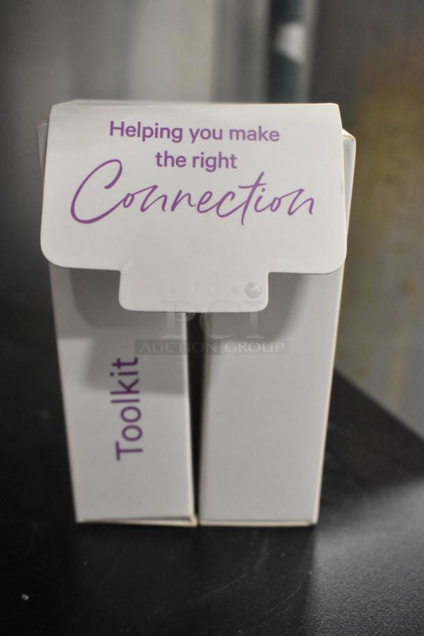 Box labeled "Toolkit" with "Helping you make the right Connection" text, part of assorted auction items.