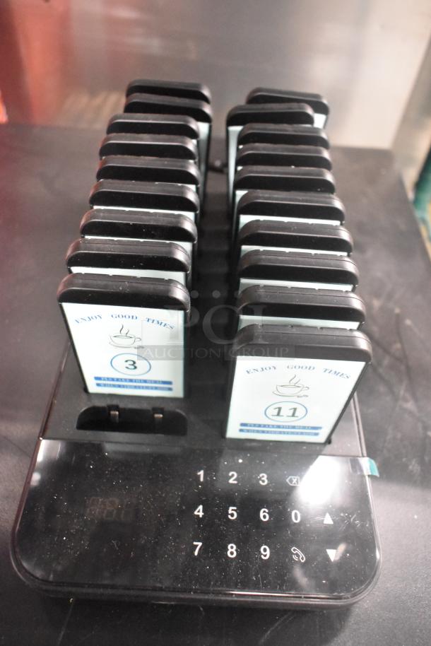 Pager system with charger and 19 pagers, featuring "Enjoy Good Times" text with numbers visible on display.