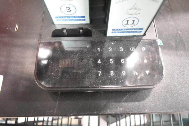 Paging system base with numbers and indicators, slightly dusty. Holds pagers labeled 3 and 11, each with usage instructions.