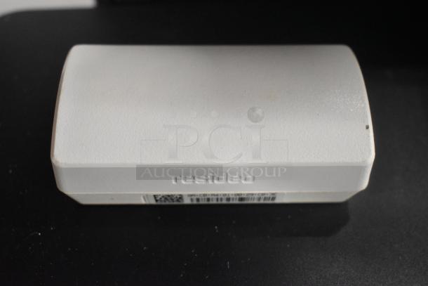 Resideo device on black surface, showing embossed branding and barcode. Condition appears lightly used.