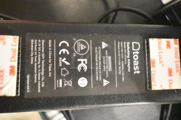 Toast switching adapter label with specifications: Model SC12V400, input 100-240V, 50/60Hz, output 24.0V, Shenzhen SOY Technology Co.