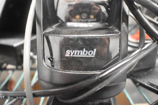 Symbol barcode scanner with visible label in used condition. Part of a lot with Toast POS monitors and card reader.