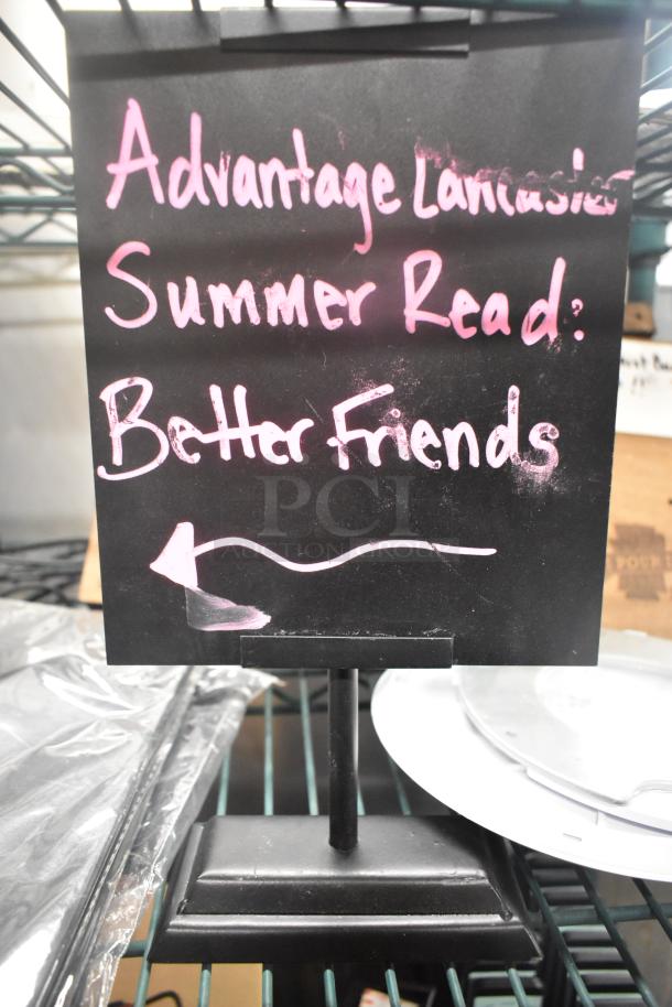 5 items including Unifin speaker, Wearson LCD monitor stand on display. Sign reads "Advantage Lancaster Summer Read: Better Friends."