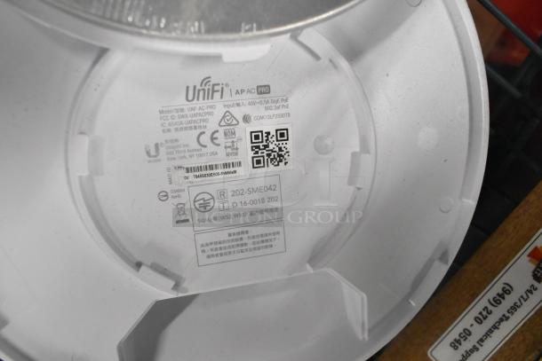Various items including UniFi AP AC Pro with visible labeling. Auction lot offers five times your bid.
