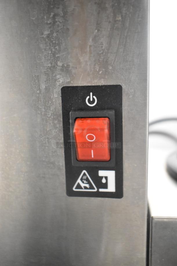 Avantco 177CMA3L coffee machine detail, showing red power switch on stainless steel surface with safety indicator.