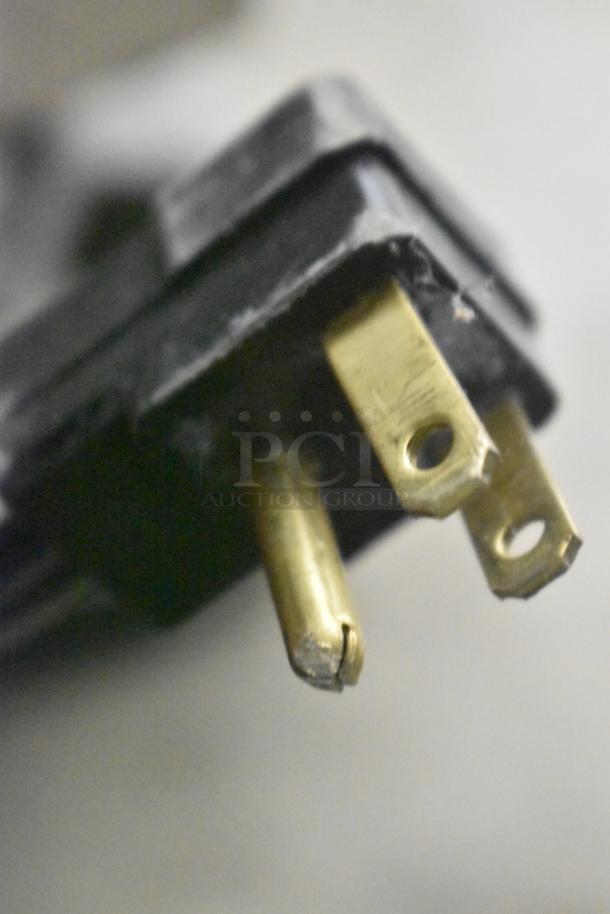 Close-up of electrical plug prongs, part of the Beverage Air SPE60HC-10 commercial prep table.