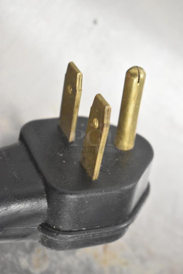 Close-up of a three-prong power plug for Xpresschef Rapid Cook Oven.