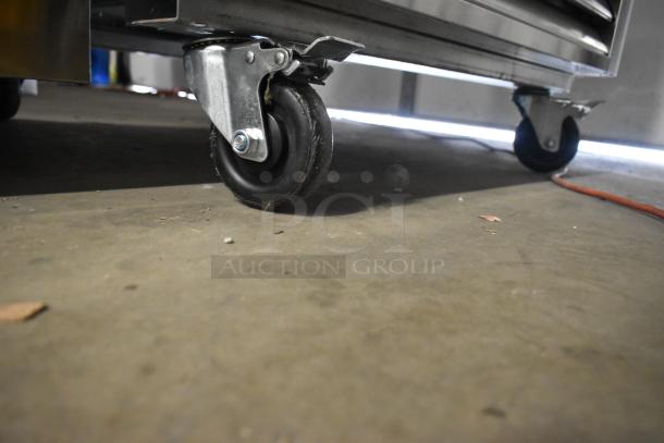 2024 Atosa MCF8705GR stainless steel cooler on commercial casters, one caster missing, 115V, 1 phase, poly-coated racks.