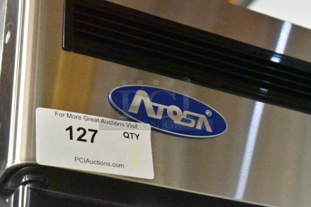 2024 Atosa MCF8705GR stainless steel cooler, single door, poly-coated racks, on commercial casters, missing one caster.