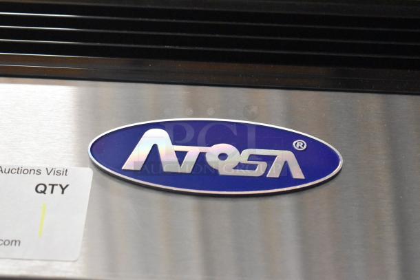 Atosa 2021 MCF8703ES logo on stainless steel commercial freezer; includes poly-coated racks, missing left door, on casters.