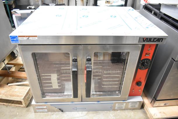 Brand new Vulcan VC4ED stainless steel commercial electric convection oven. Features view-through doors, metal racks, and thermostatic controls. Scratch and dent condition, 240 volts.