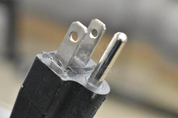 Close-up of a power plug for Avantco 177MX30H 30 Qt. mixer. The metal prongs are visible against the black plastic plug.
