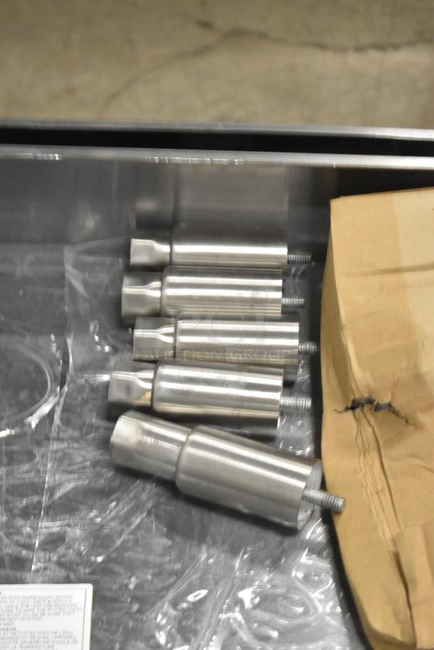 Stainless steel parts and packaging from Cooking Performance Group 351GTCPG72NL griddle, showcasing new condition.