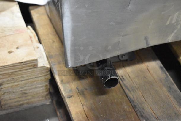 Stainless steel corner detail of Cooking Performance Group 351GTCPG72NL griddle, showing scratch and dent damage.