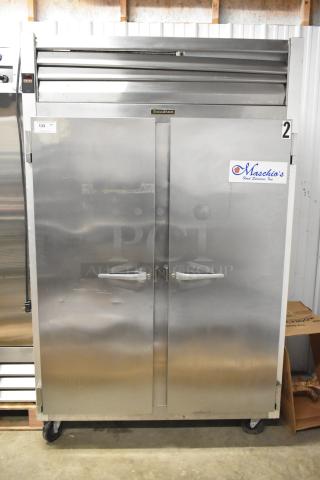 Traulsen G22010 stainless steel 2-door reach-in freezer with poly-coated racks, on casters. 115V, 1-phase.