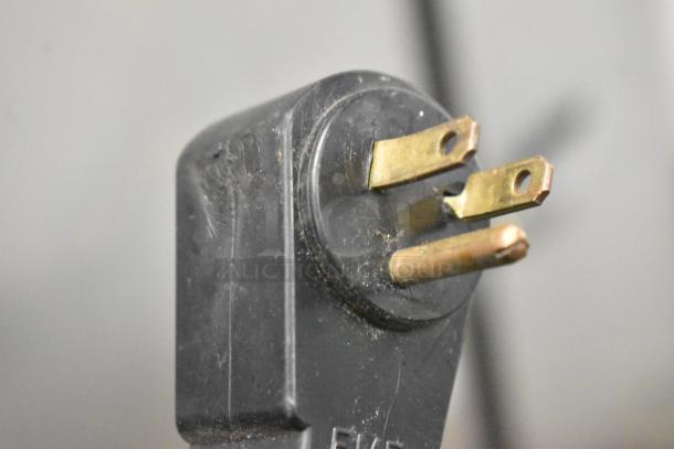 Close-up of a plug for the Traulsen G22010 Commercial Freezer, showing the electrical prongs.