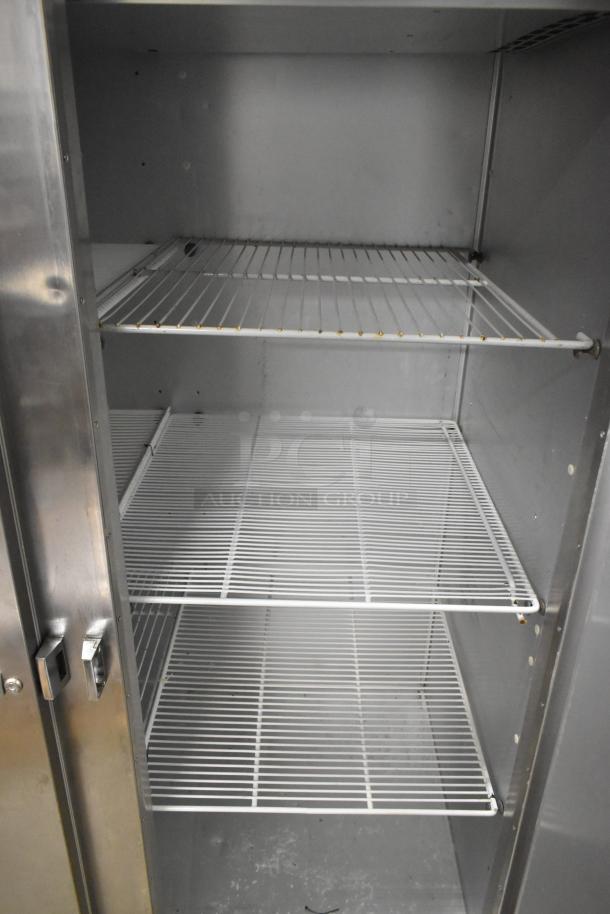 Traulsen G22010 stainless steel commercial freezer with two doors, poly-coated racks, and commercial casters. 115V, 1 phase.