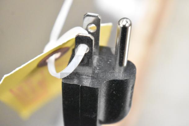 Close-up of Curtis CAFE0AP10A000 coffee brewer plug with attached tag. Model is brand new, scratch and dent condition. 120V.