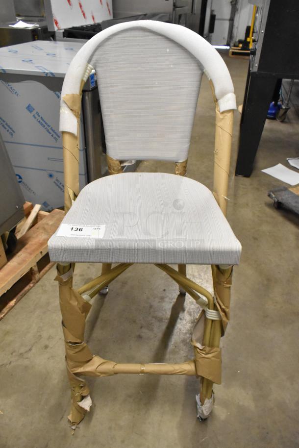 Brand new bar height chair with a white back and seat. Wooden frame, minor scratches, labeled "136" for auction.