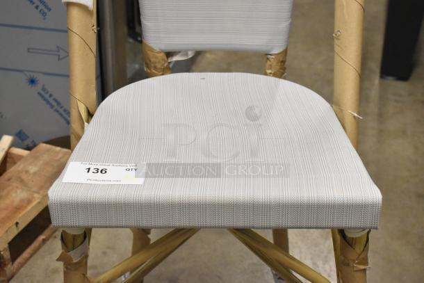 Wooden bar height chair with white backrest and seat, brand new with minor scratches and dents, wrapped for protection.