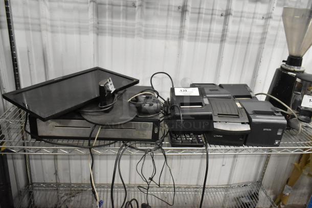 Nine-item lot including metal cash drawer, five Epson receipt printers, computer monitor, and keyboard. Shows wear.