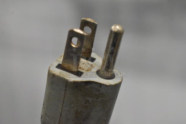 Plug of Magister M MD LA espresso machine, 115 volts, 1 phase. Missing lid noted, visible wear and oxidation on prongs.